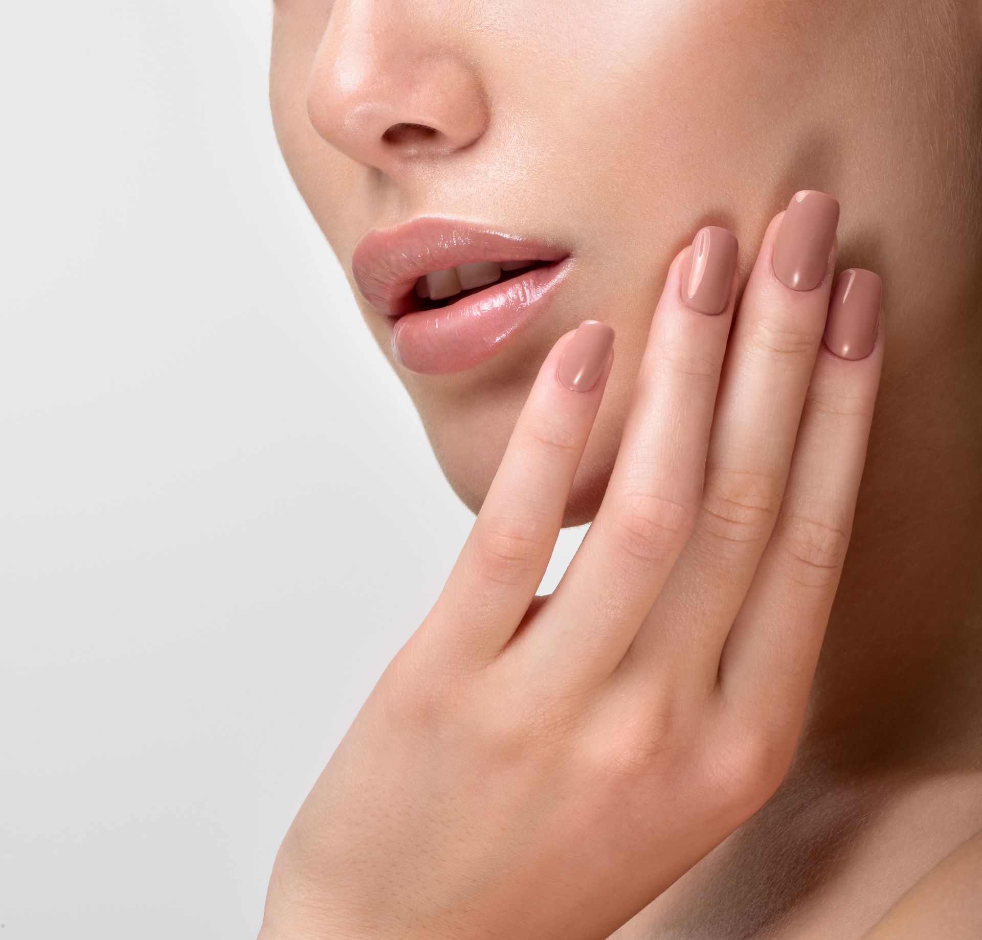 A close up of a woman 's face with her hand on her face.