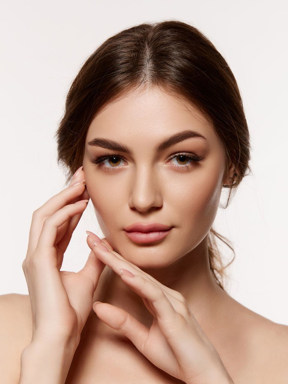 a woman with radian skin touching her face