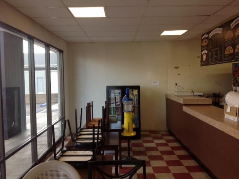 The inside of a restaurant with tables and chairs empty