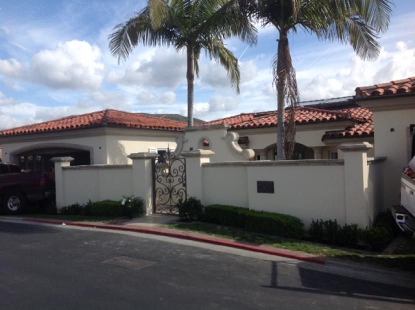 A white house with a palm tree in front of it