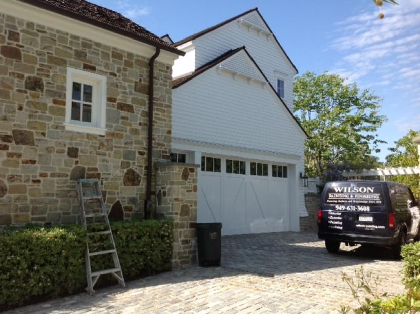 A wilson van is parked in front of a stone house