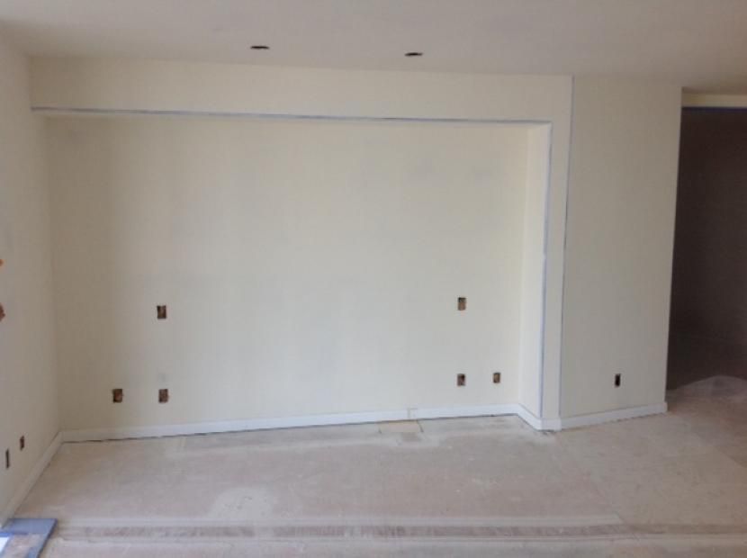An empty room with white walls and a corner.