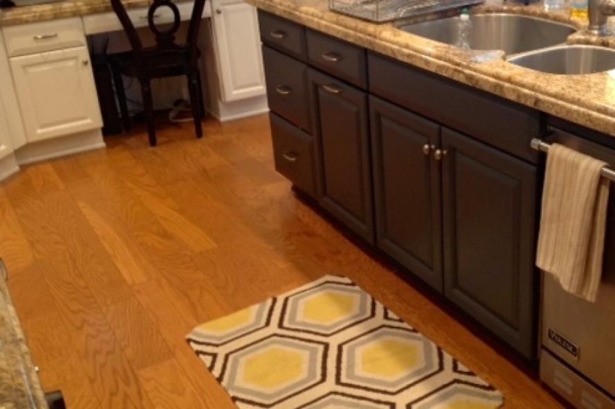 A kitchen with a rug on the floor and a bosch dishwasher