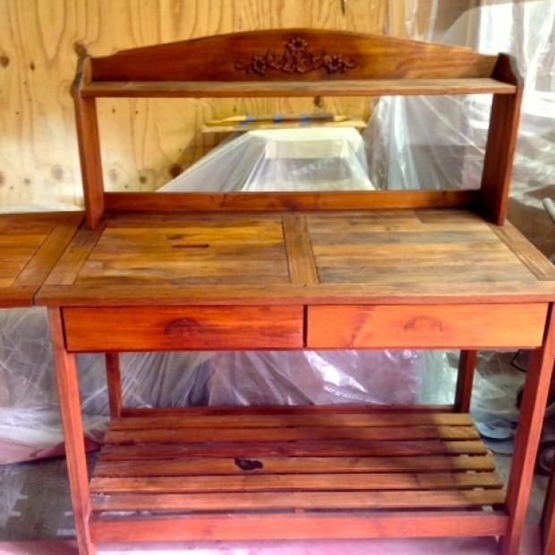 A wooden table with two drawers and a shelf