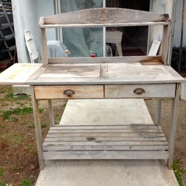 A wooden table with two drawers and a shelf
