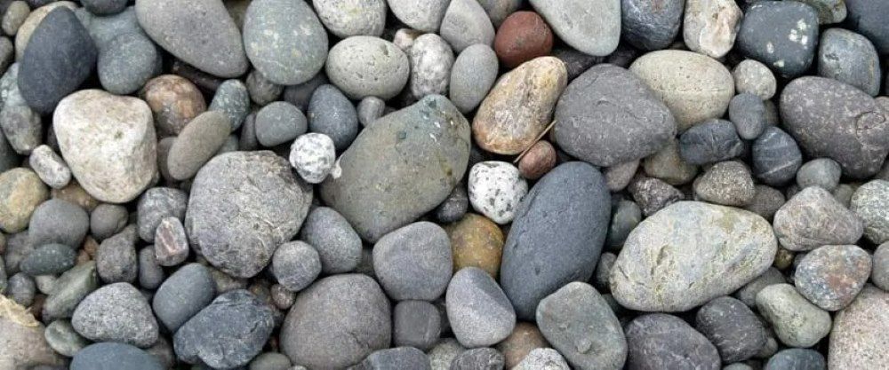 Close-Up of Various Rounded River Rocks in Shades of Gray, Brown — Cessnock Landscaping Supplies In Cessnock, NSW