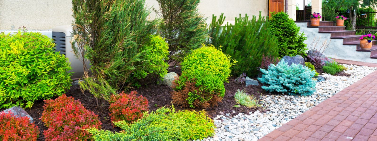 Colorful, Manicured Garden with Various Shrubs, Stone Pathway — Cessnock Landscaping Supplies In Maitland, NSW