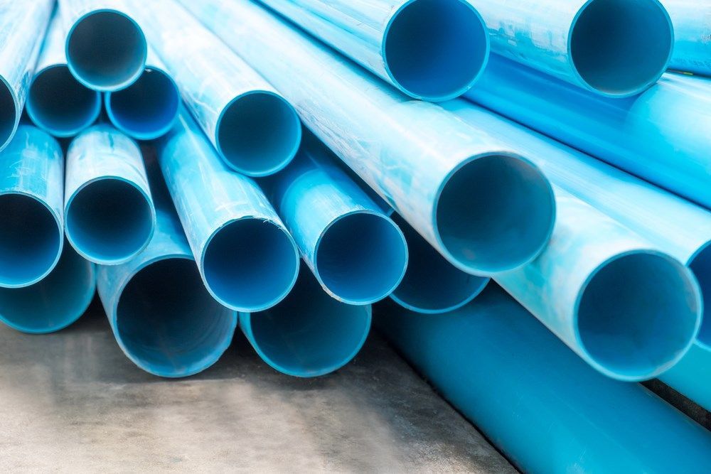 Blue Pvc Pipes Stacked Together — Cessnock Landscaping Supplies In North Rothbury, NSW