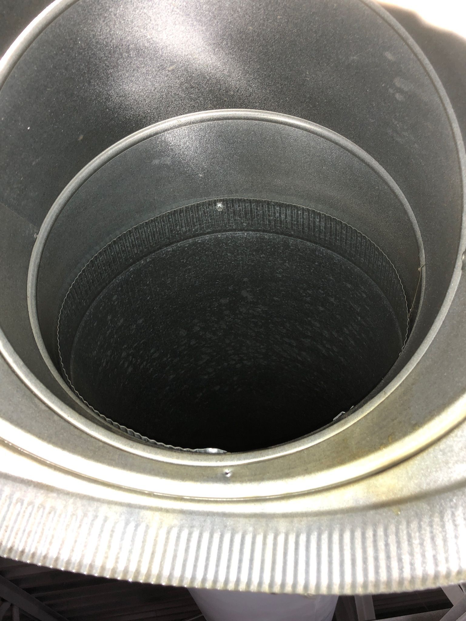 A close up of the inside of a metal pipe.