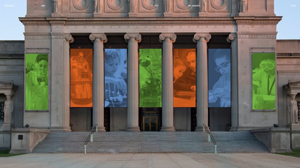 A large building with columns and banners on the front of it