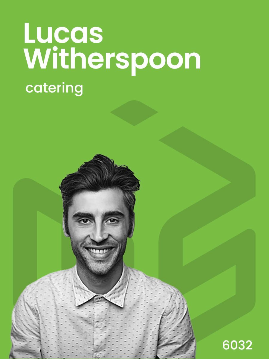 A black and white photo of a smiling man on a green background.