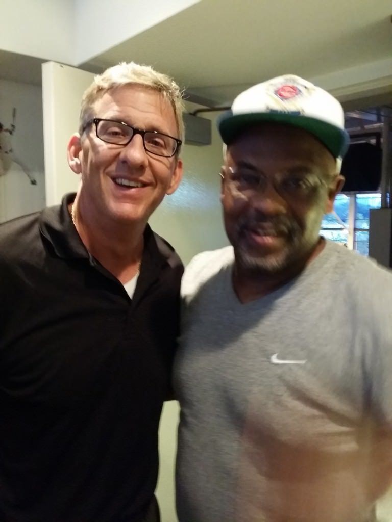 Two men posing for a picture one wearing a nike shirt