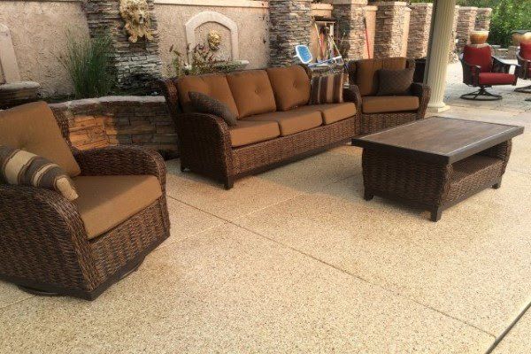 A patio with a couch , chairs and a coffee table