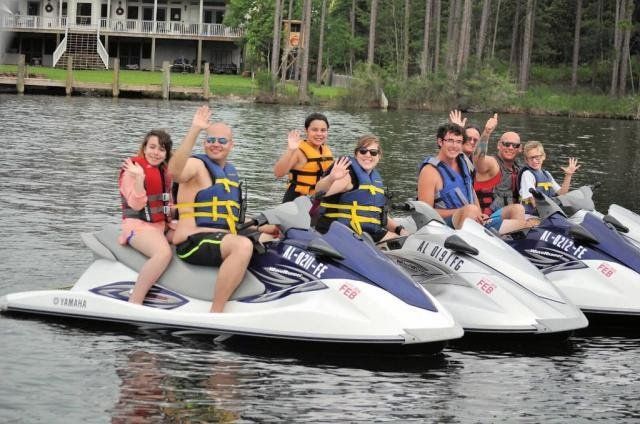 A group of people are riding jet skis on a lake