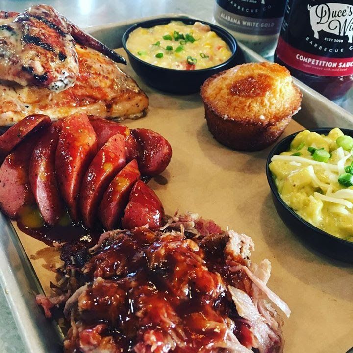 A tray of food including sausage mashed potatoes and cornbread