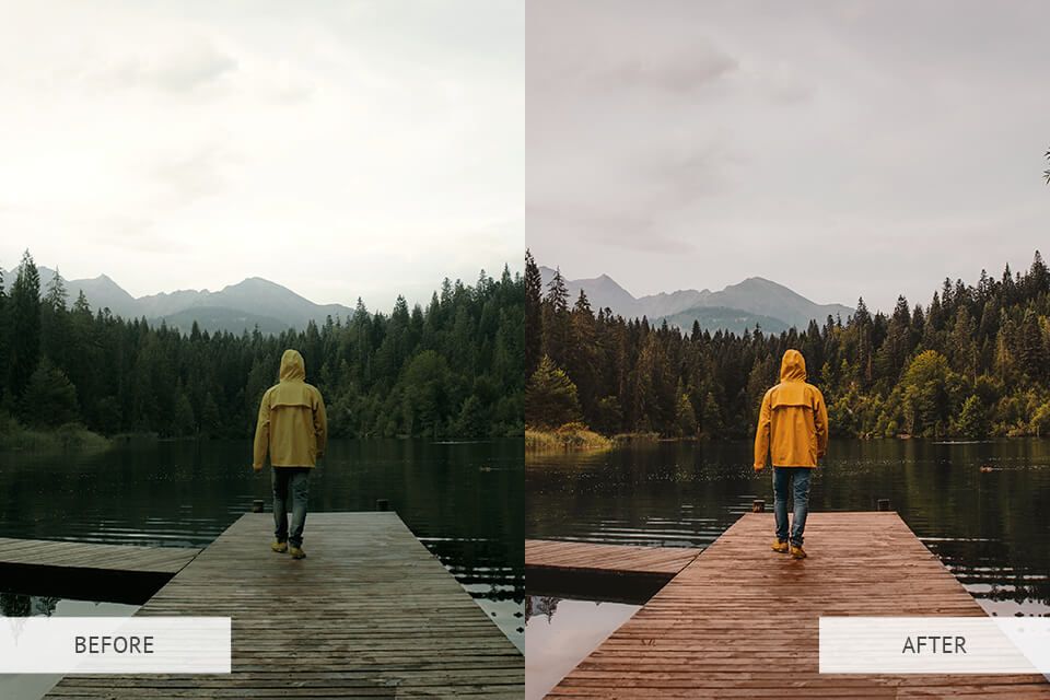 A man in a yellow jacket is walking on a dock next to a lake.