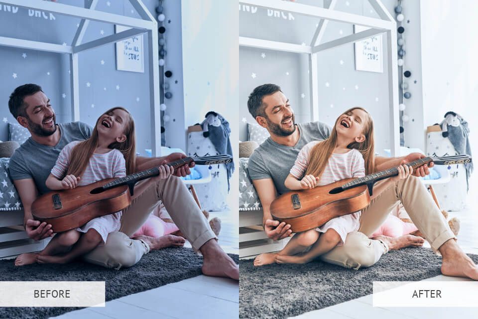 A man and a little girl are sitting on the floor with a guitar.