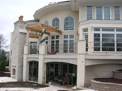 A large white house with a balcony and a pergola