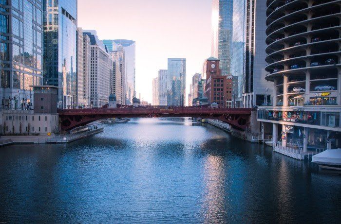 There is a bridge over a river in the middle of a city.