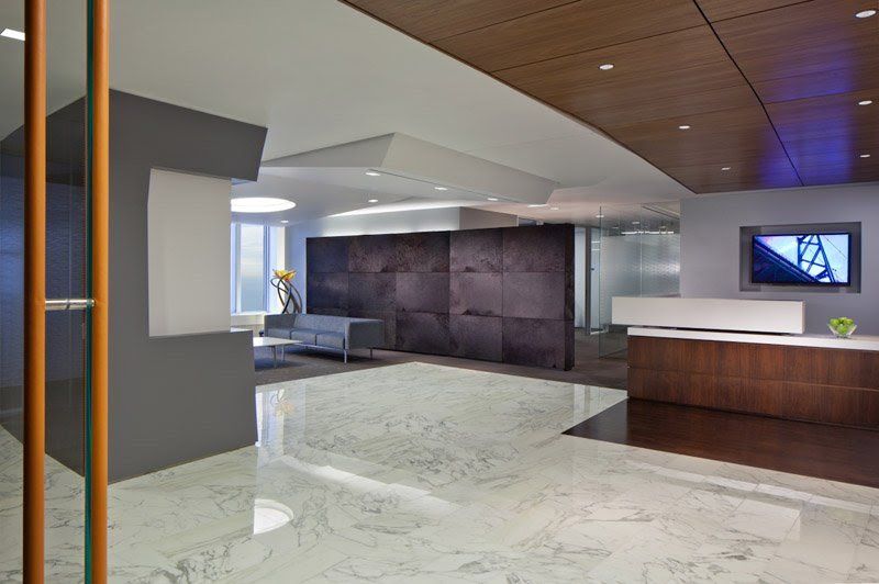 A lobby with a couch and a tv on the wall