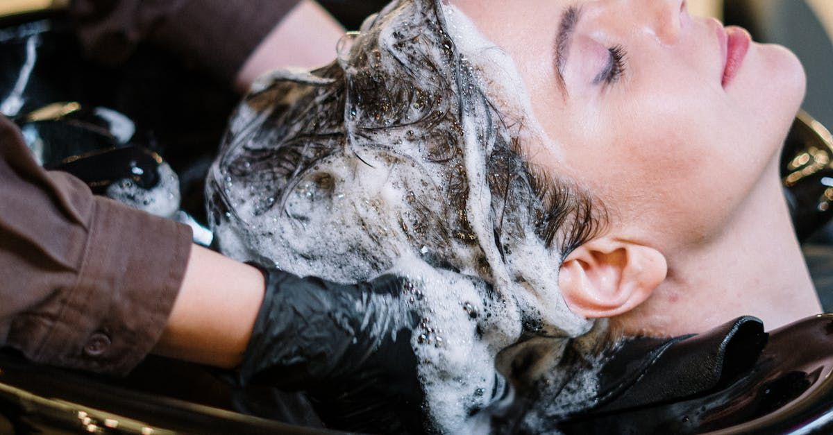 A woman is getting her hair washed at a salon.