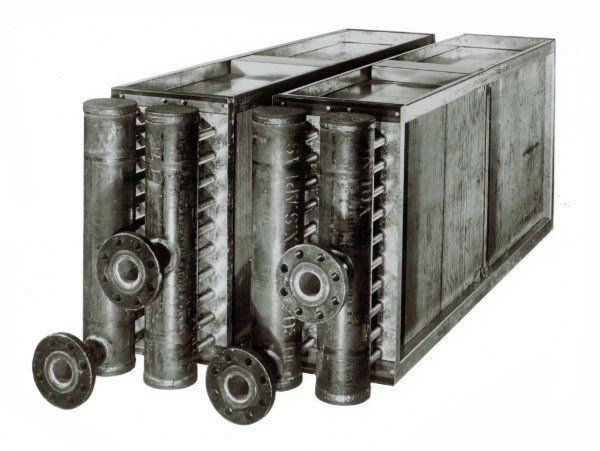 A black and white photo of a metal container with pipes attached to it.