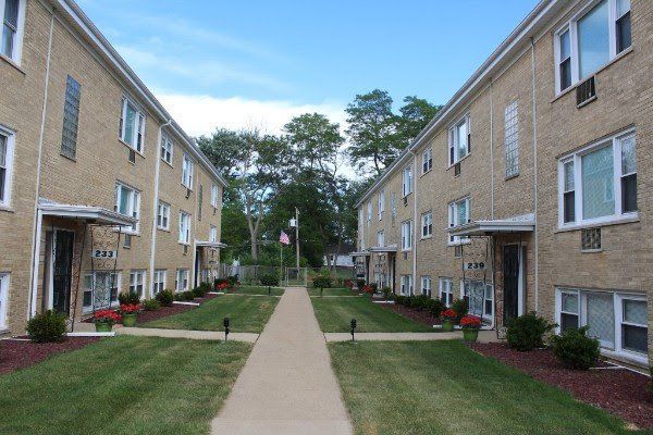 A row of apartment buildings with a walkway between them