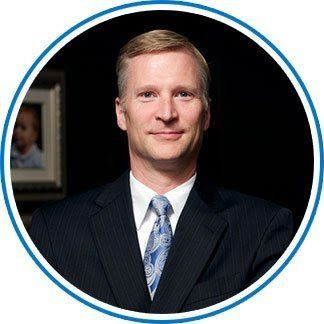 A man in a suit and tie is standing in a circle.