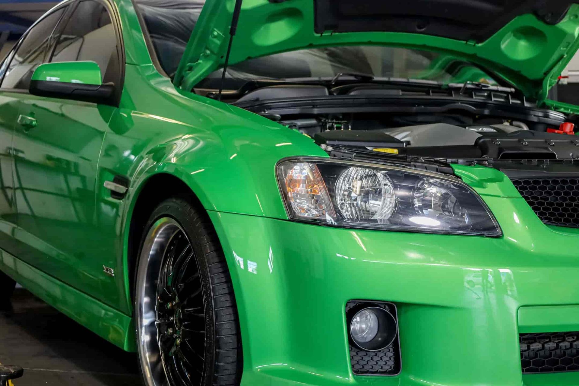 A Green Car With the Hood Open is Sitting in a Garage — Ultra Tune Nambour In Nambour, QLD