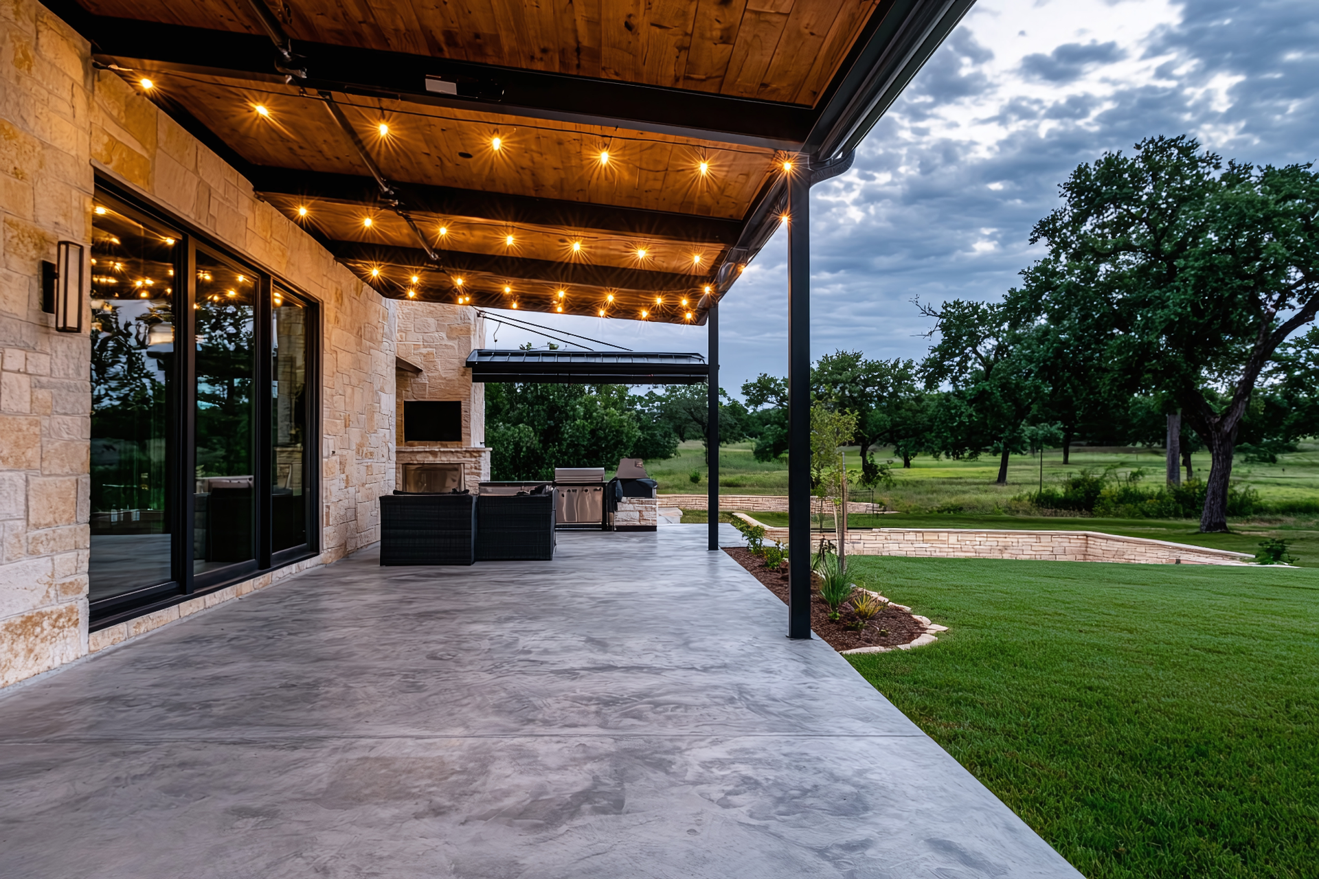 A large patio with a wooden roof and lights on it.