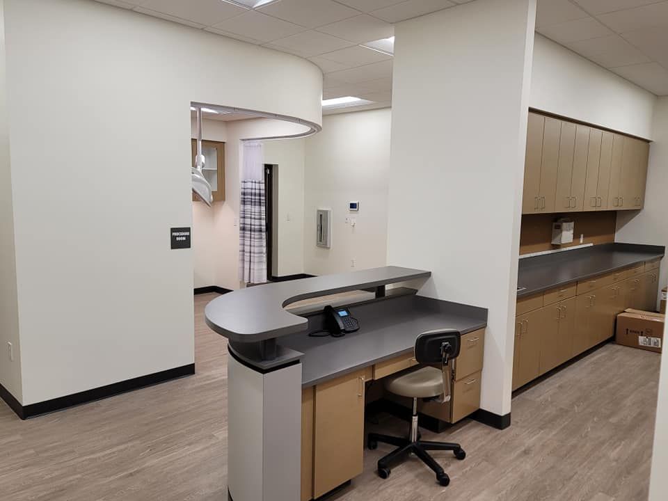 A dental office with a desk and a chair