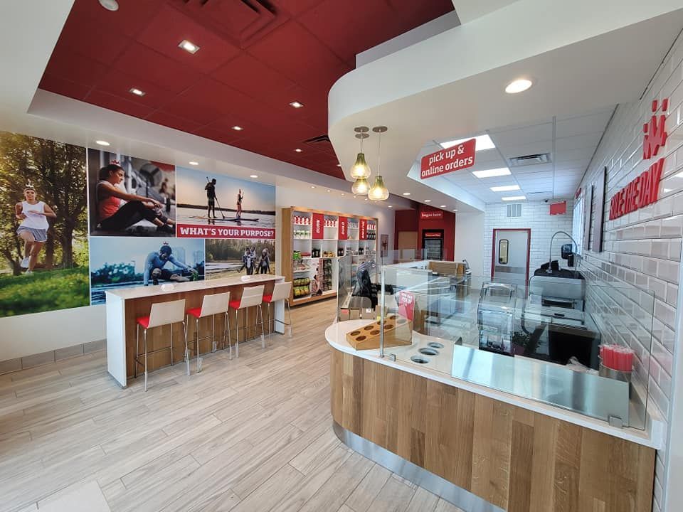A restaurant with a red ceiling and a wooden counter.