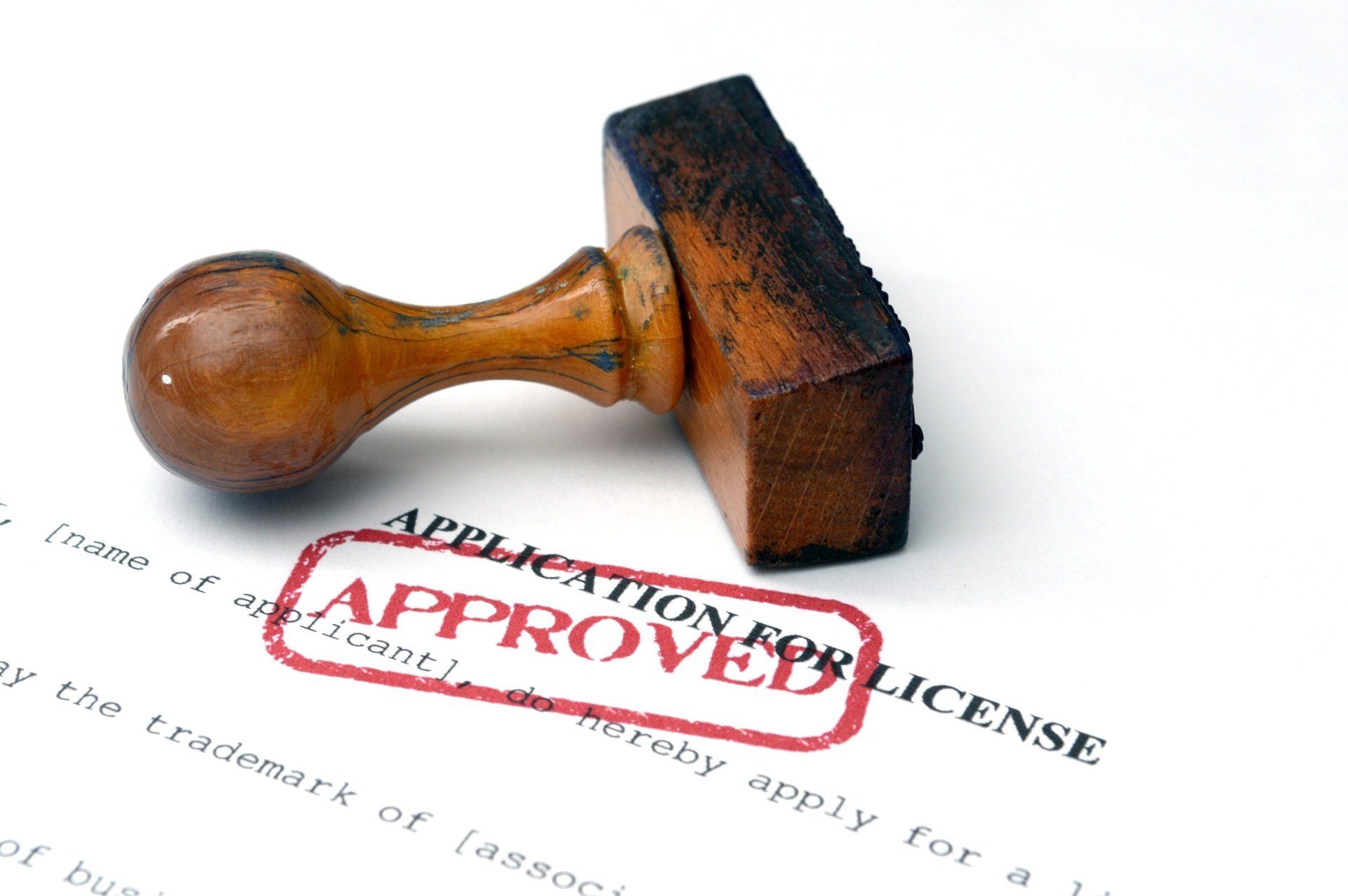 A stamp on a piece of paper that says application for license approved