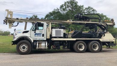A Large Truck is Parked in a Grassy Field — Graceville, FL — Bush Services Inc.