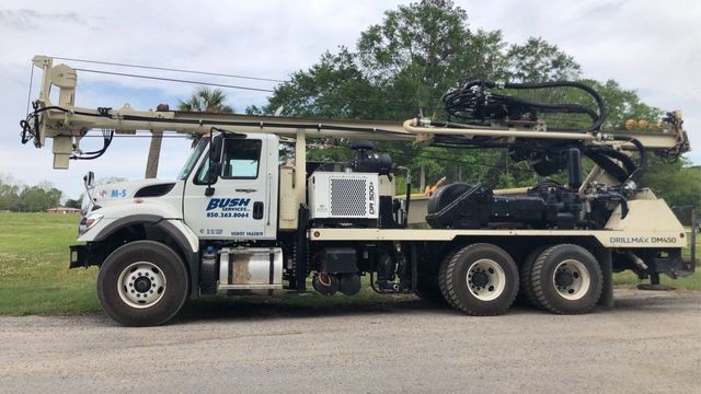 A Large Truck is Parked in a Grassy Field — Graceville, FL — Bush Services Inc.