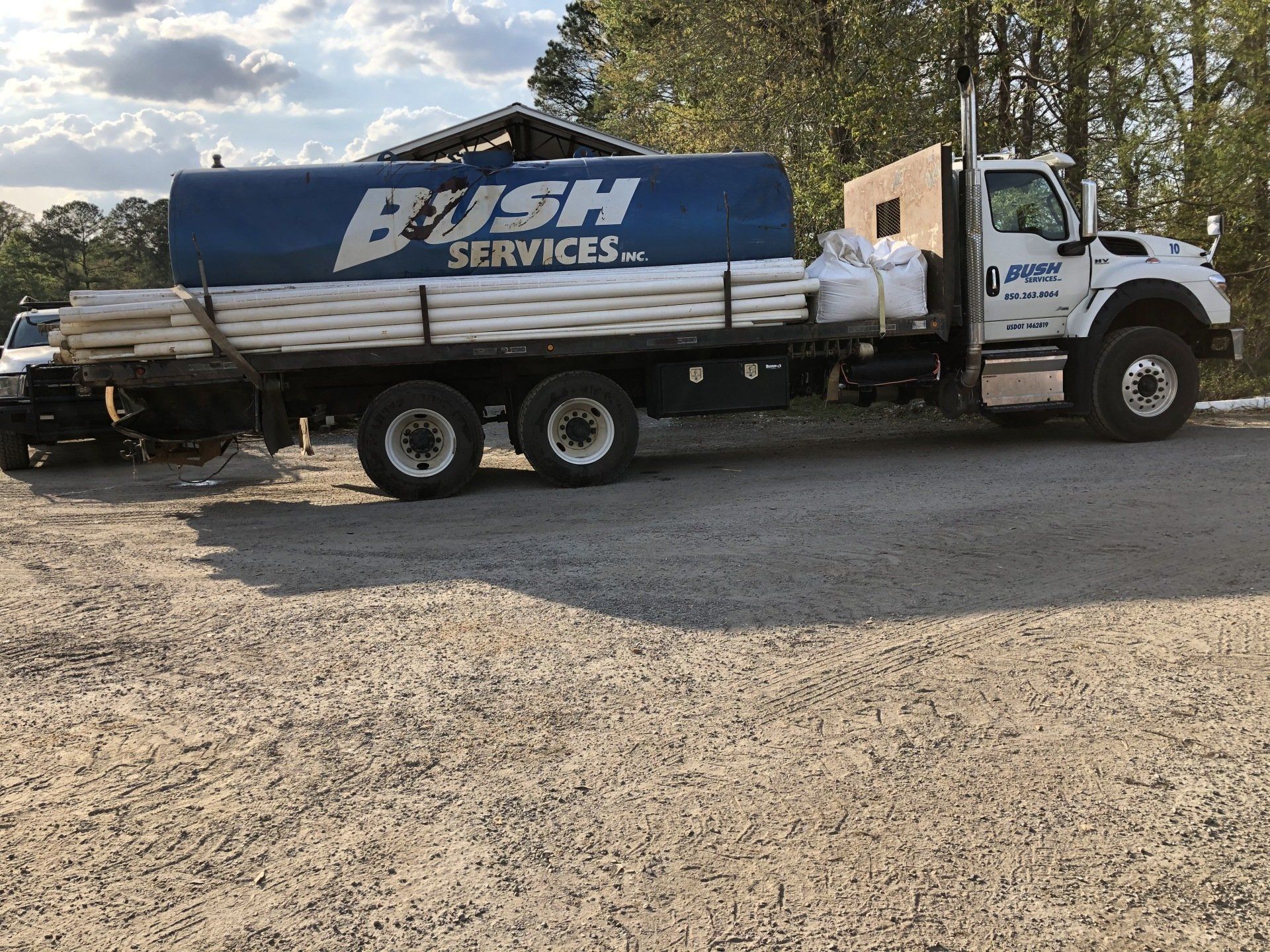 A Bush Services Truck is Parked in a Gravel Lot — Graceville, FL — Bush Services Inc.