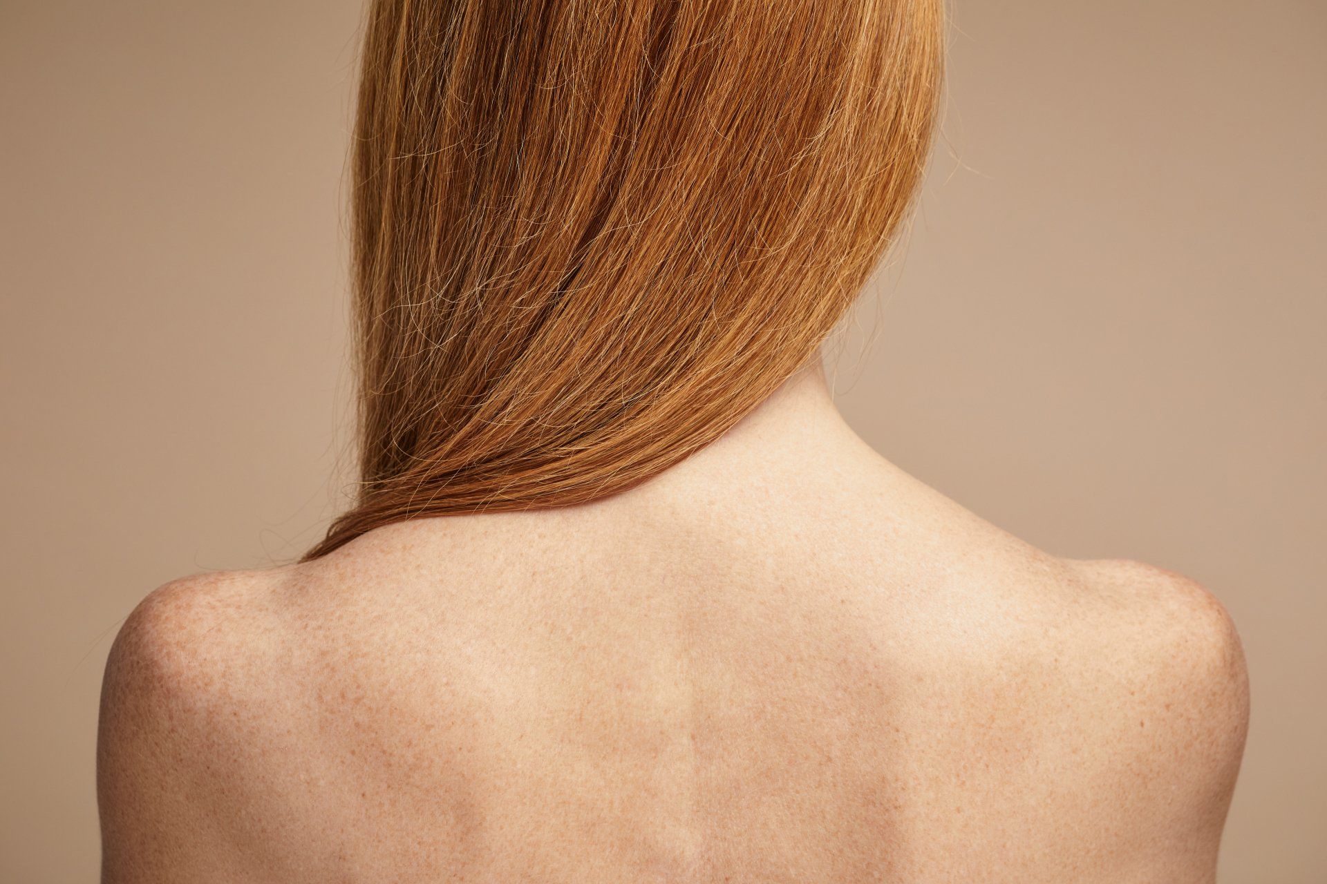 rear view of woman's shoulders and back and long hair