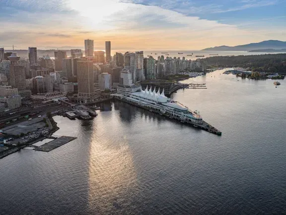 An aerial view of Vancouver with a large body of water in the foreground.