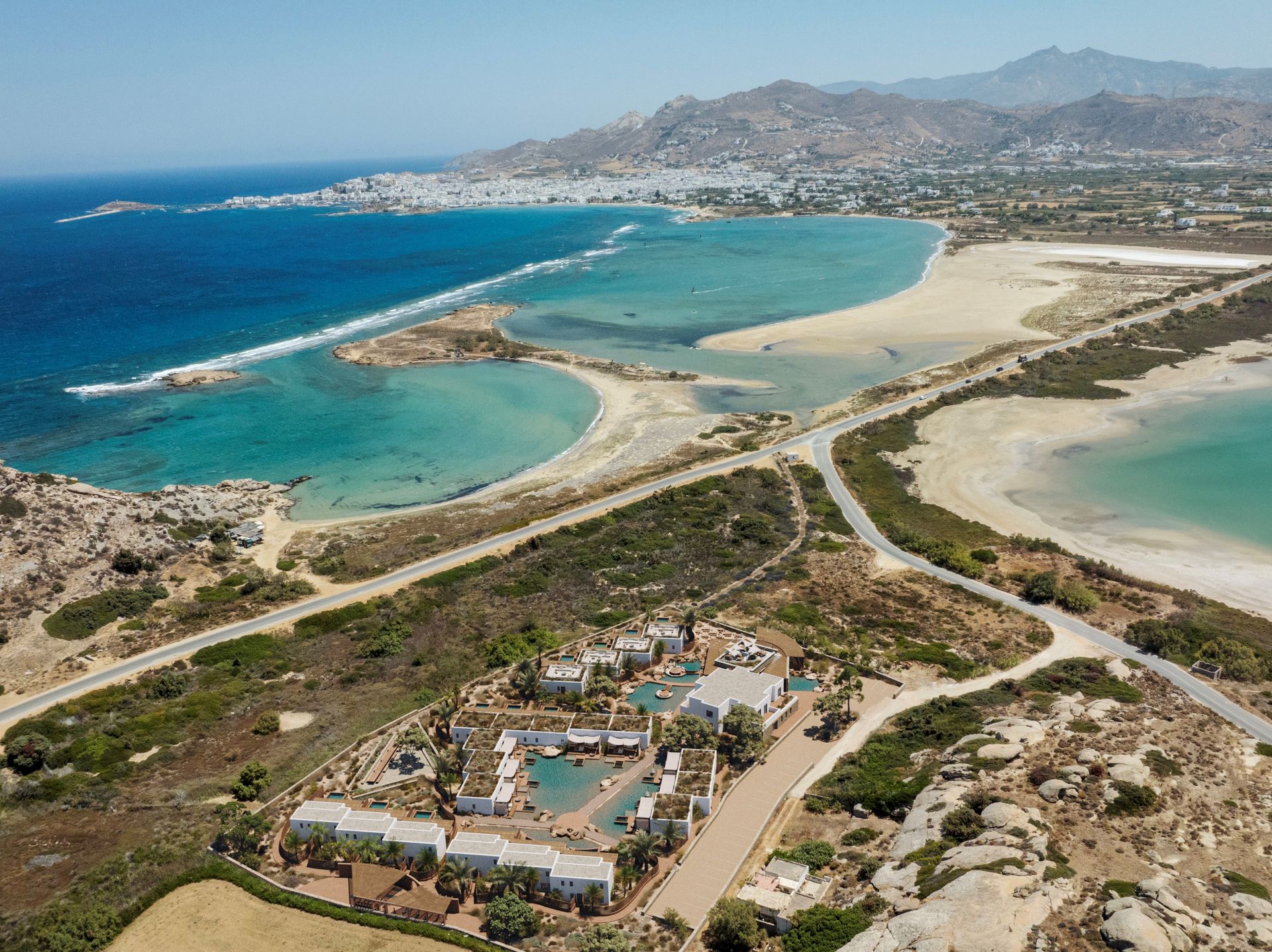 An aerial view of Laguna Coast Resort and the beach with mountains in the background in Naxos, Greece. 