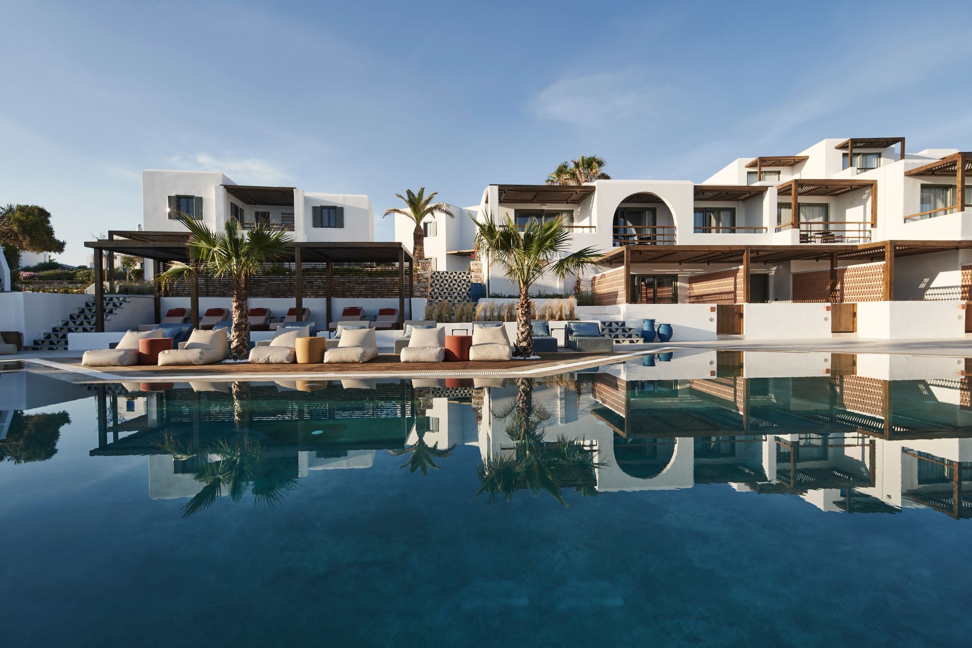 Andronis Minois Hotel with a swimming pool in front of it in Paros, Greece.