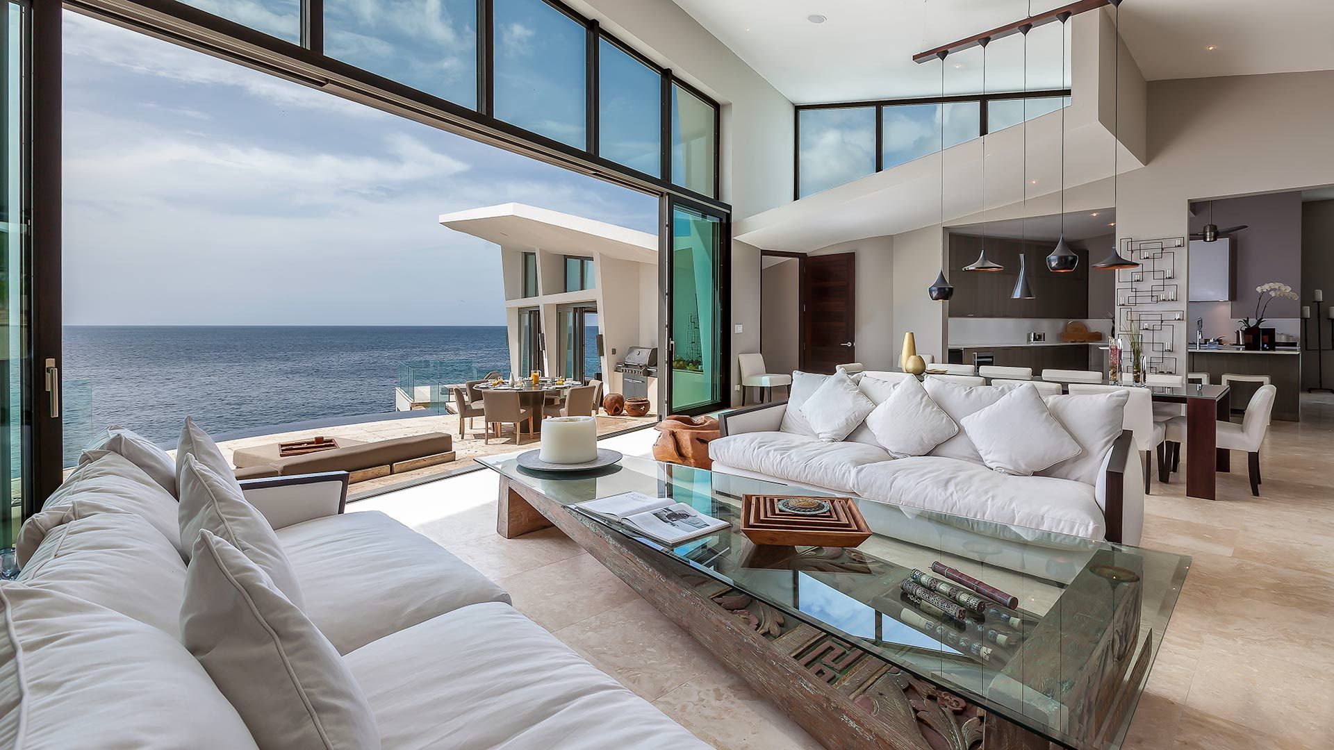 A living room with a view of the ocean at villa in Antigua.