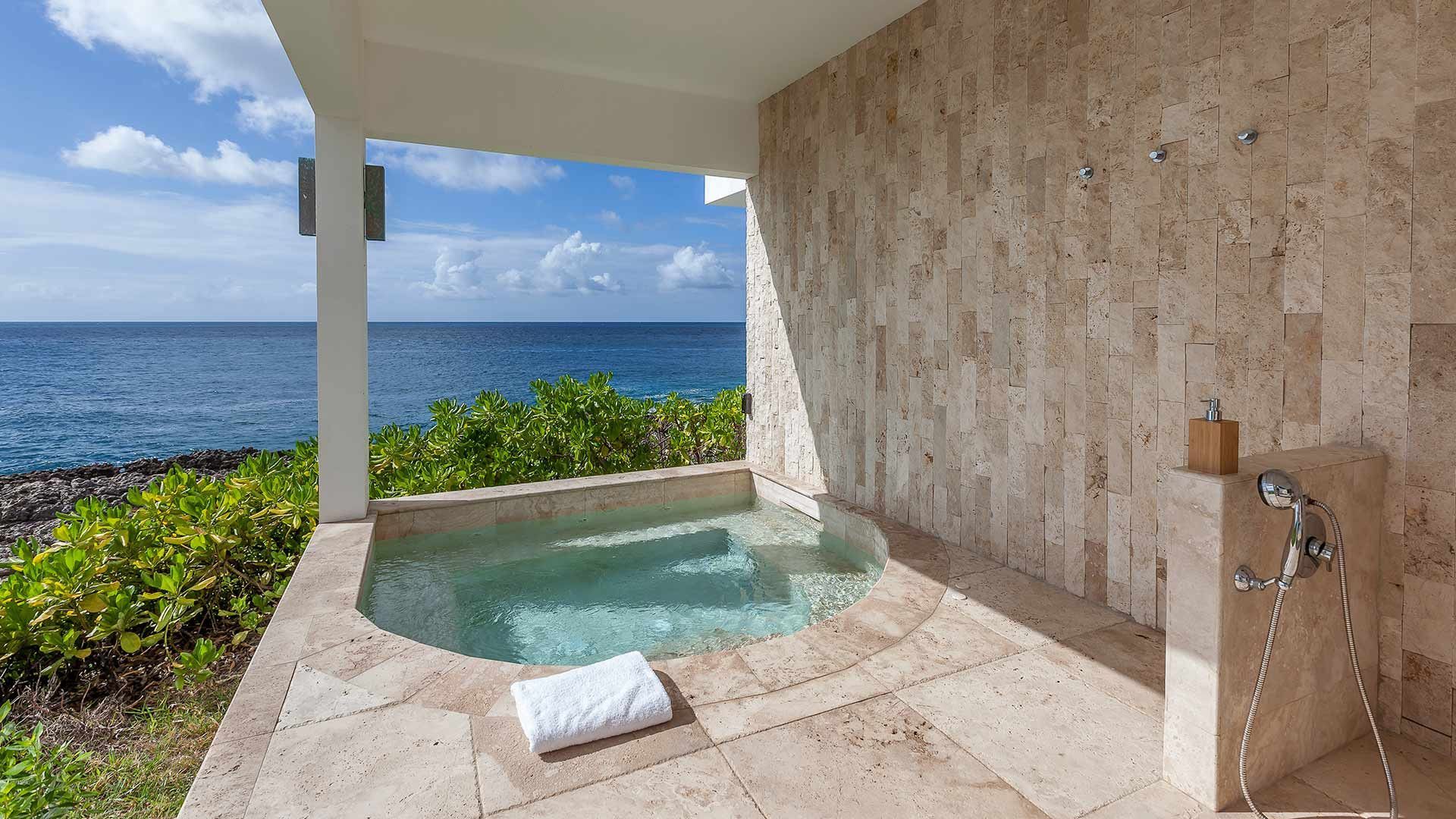 There is a hot tub with a view of the ocean at villa in Antigua.