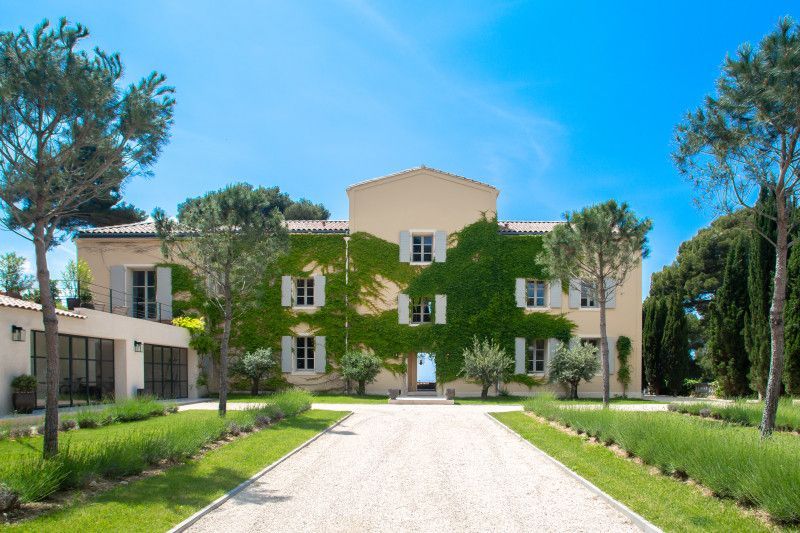 A large villa with a driveway leading to it in Cote D'Azur, France.