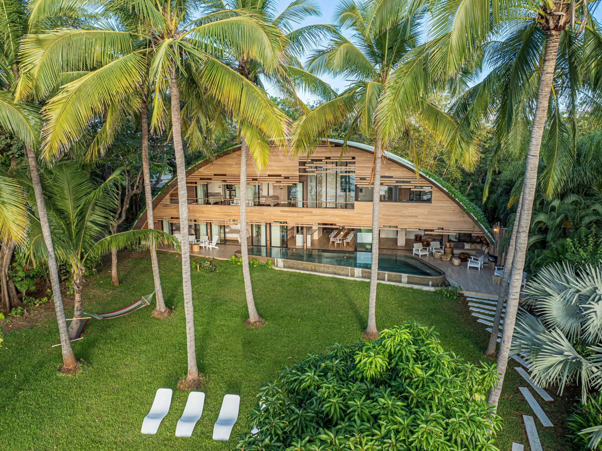 An aerial view of a large villa surrounded by palm trees in Costa Rica.