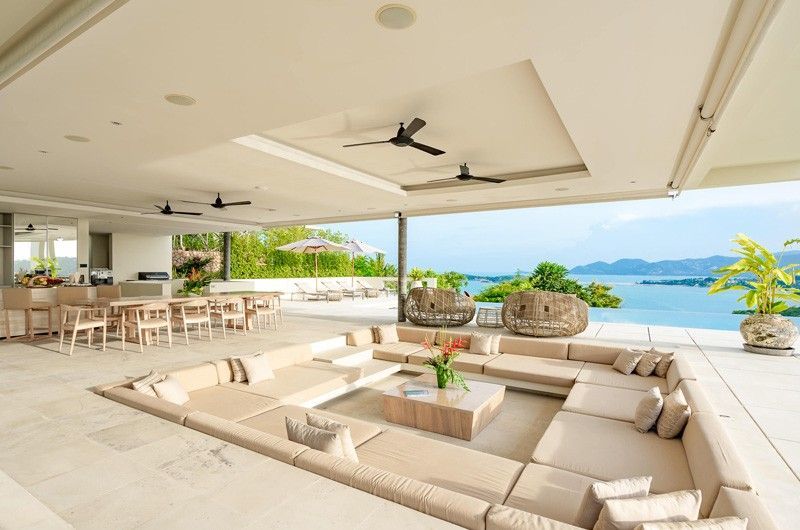 There is a large couch in the middle of the room at villa in Koh Samui, Thailand.