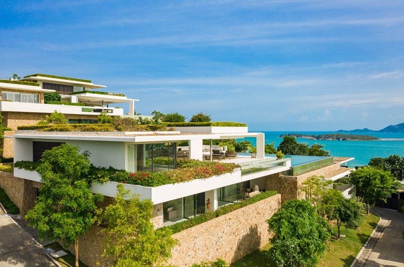 An aerial view of a large modern villa with a view of the ocean in Koh Samui, Thailand.