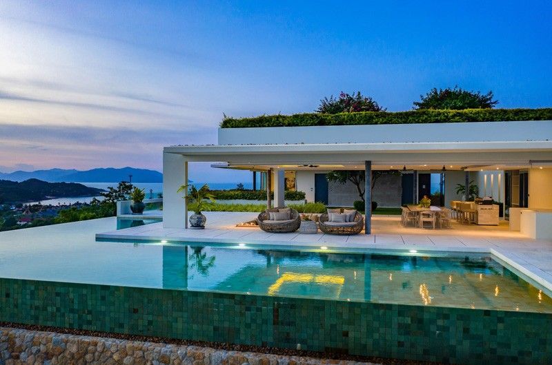 A modern villa with a swimming pool and a view of Koh Samui, Thailand.