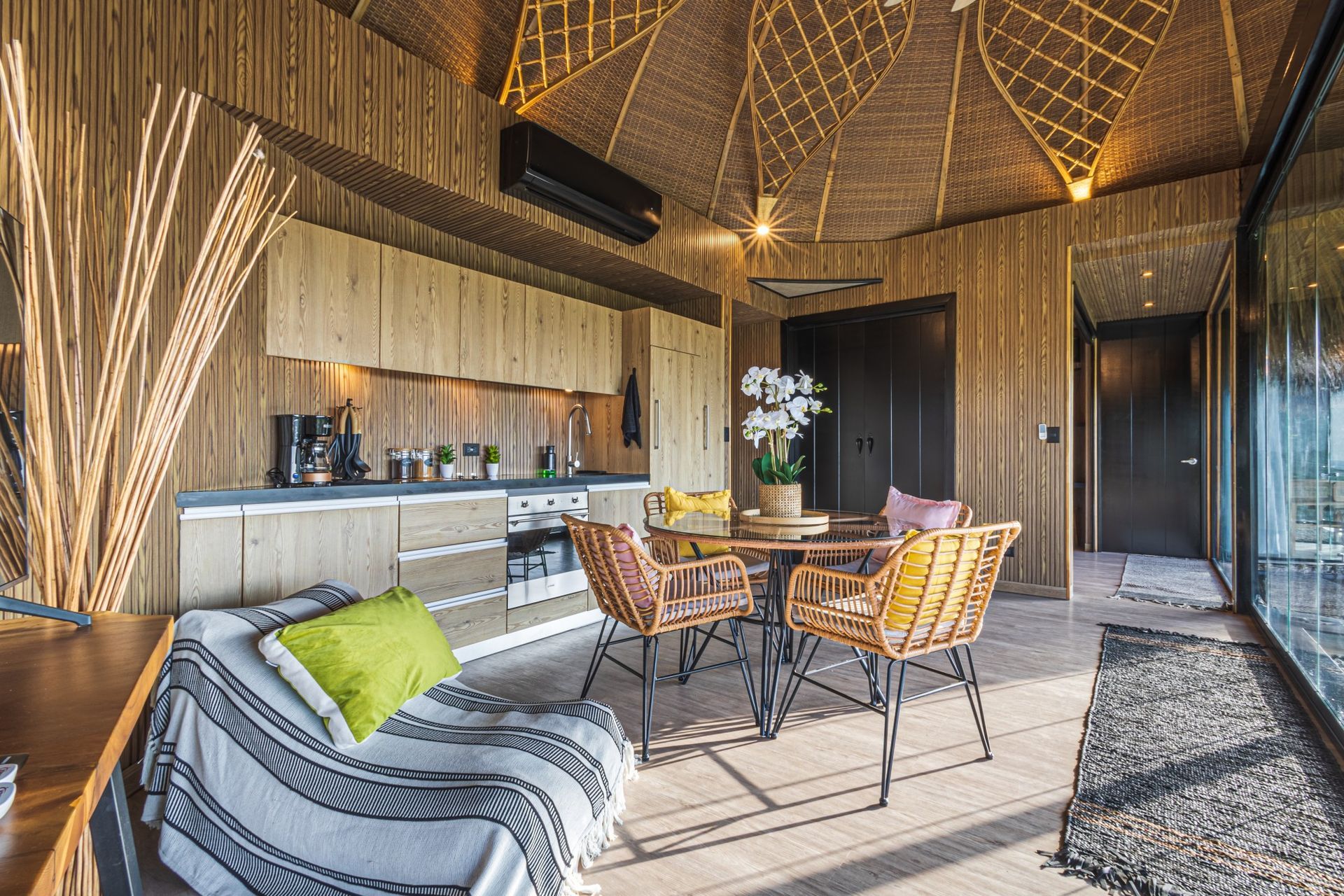 A living room with a table and chairs and a kitchen in villa at villa in Costa Rica.