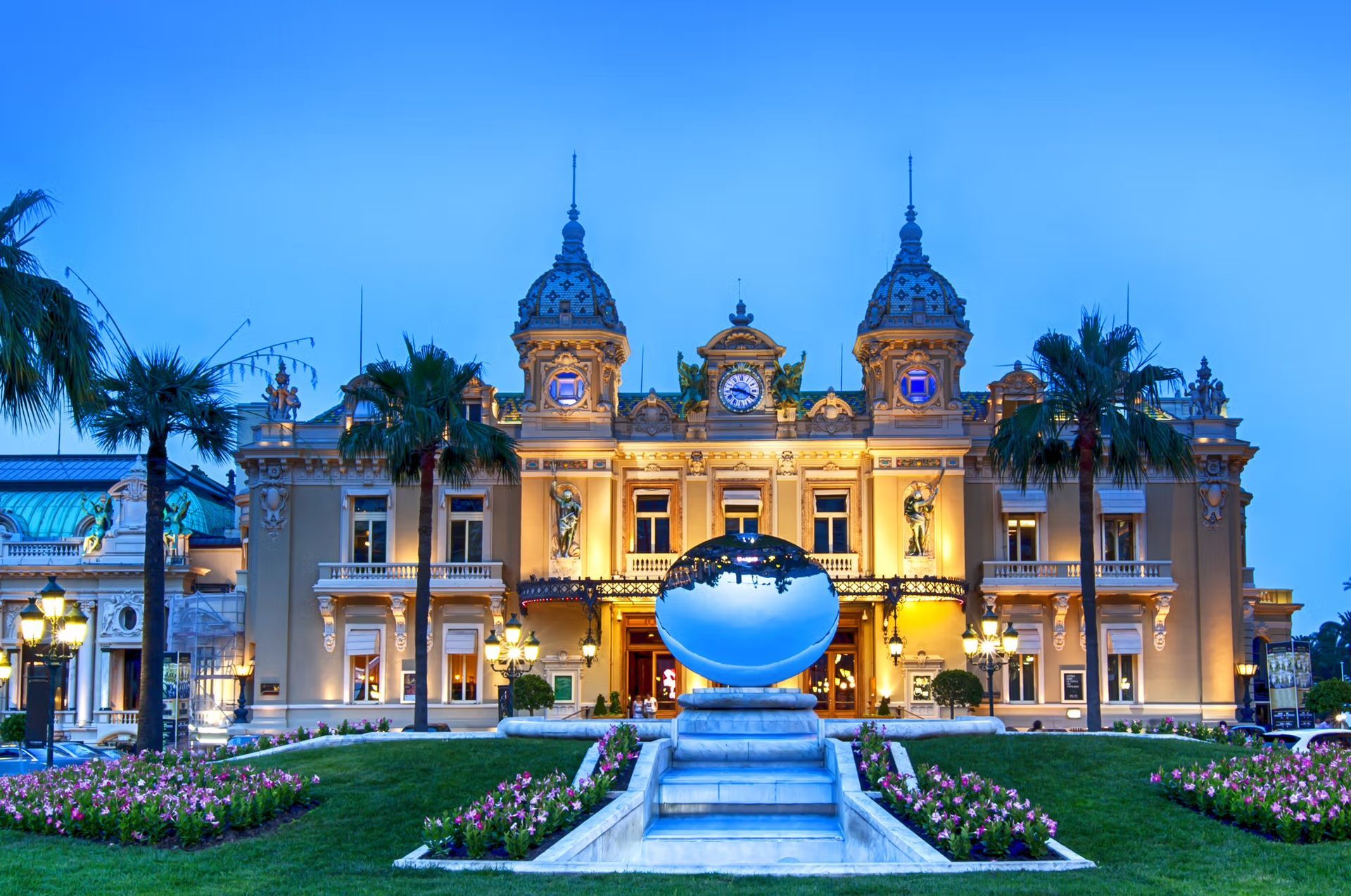 Casino in Monaco with a fountain in front of it in Monaco.
