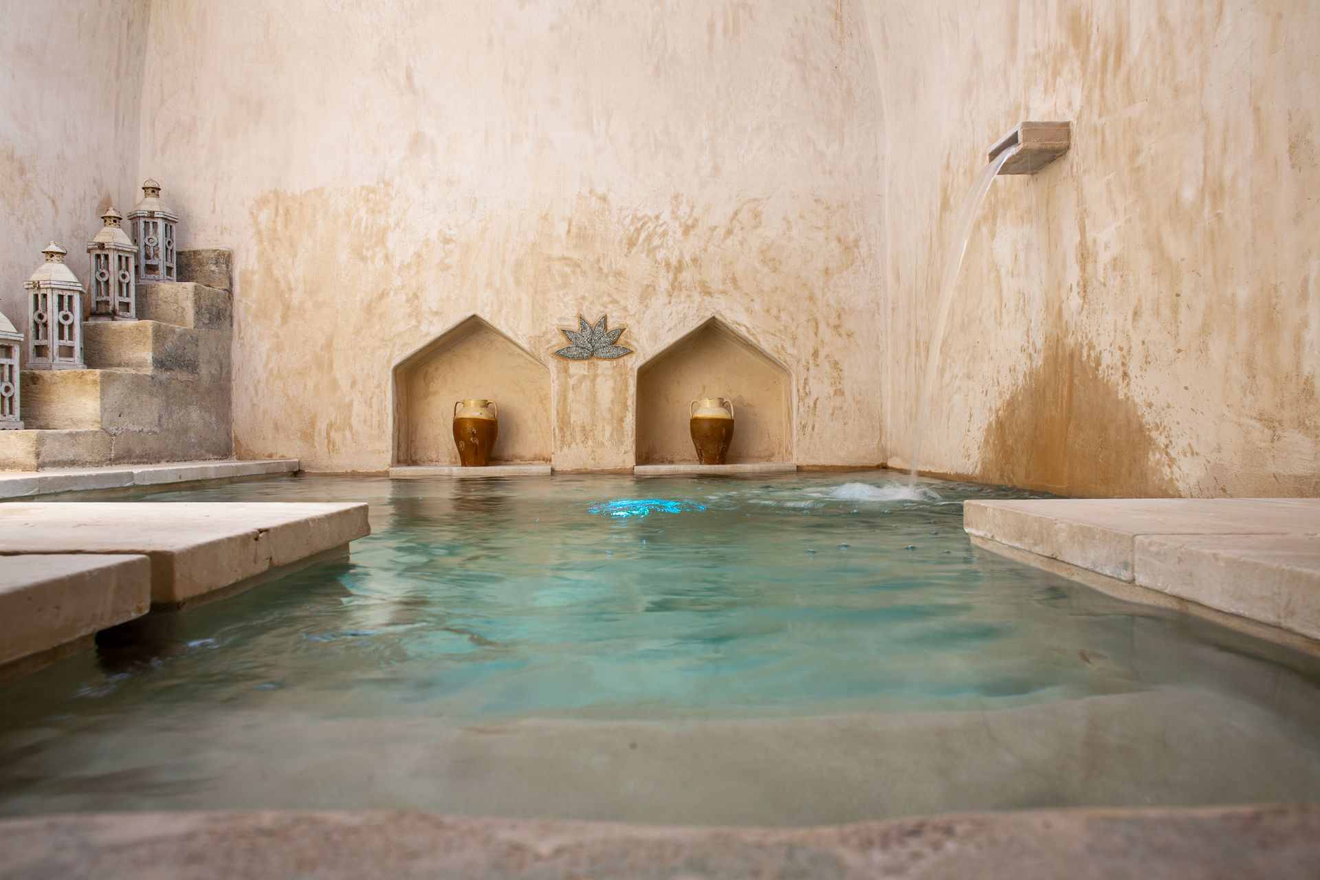 There is a large swimming pool in the middle of the room at Naturalis Bio Resort & Spa in Puglia.